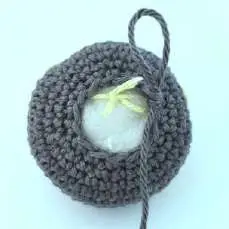 Tying the blush yarn ends together inside the bat head