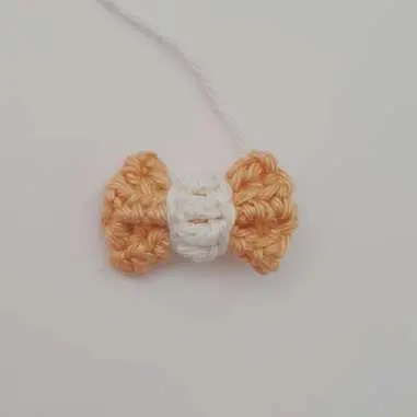 Finished orange crochet bow tie with a white knot