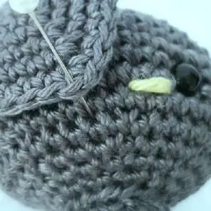 Crochet bat ear pinned at the front corner next to the blush