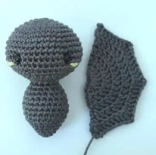Bat head and body next to a wing to compare their size