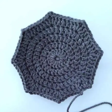 Flat gray crochet wing piece worked in rounds with eight points