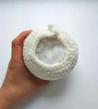Stuffing the crochet bunny body with fiberfill