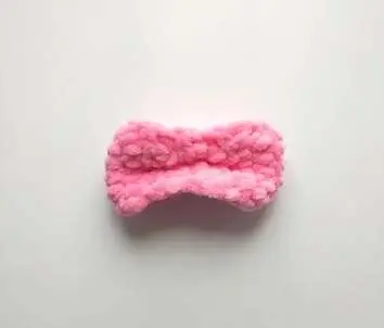 Pink crochet bow folded in the middle