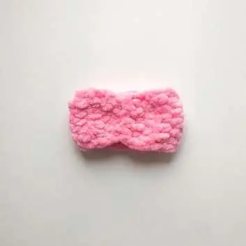Pink crochet bow strip with its ends sewn together