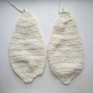 Two flat cream crochet bunny ear pieces