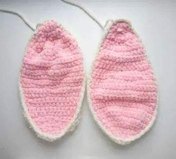 Two finished bunny ears, pink inside and cream outside, joined together