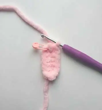 Starting a pink crochet bunny foot from a chain with a purple hook
