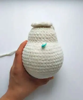 Crochet bunny head being started on top of the stuffed body